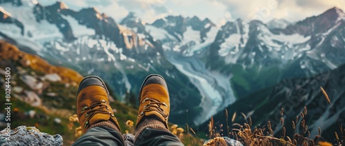 Feet trekking boots hiker relaxing with mountains landscape view outdoor Travel Lifestyle concept.