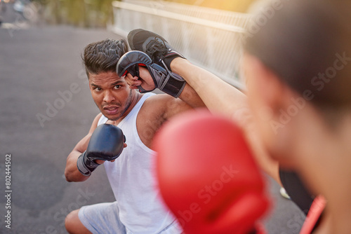 Kickboxing, fight and people training in city for fitness, workout or martial arts man on street for body health. Combat sport, gloves and coach outdoor on road for exercise, wellness and challenge