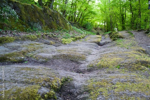 ancient street and path driven in the rock by wheels of many transportation trucks photo