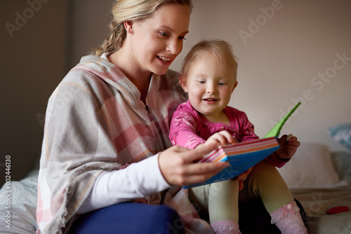 Mother, girl and bed in home with book, holding and care for childhood development and bonding or growth with mama. Child, daughter and reading or happy in bedroom, together and family relationship