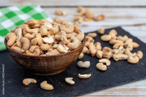 Roasted cashew nuts in bowl. Healthy snack, vegetarian food full of protein, beer snack..