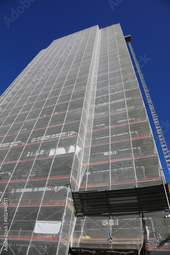 huge scaffolding of the gigantic skyscraper during maintenance to install the thermal insulation for energy saving without people photo
