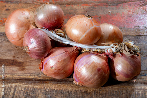 Bunch of french AOP pink onions from Roscoff village in Brittany, France