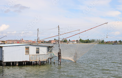 Large Adriatic Sea fishing huts called Bilancioni or Padelloni in Italy built on stilts with large fishing nets photo