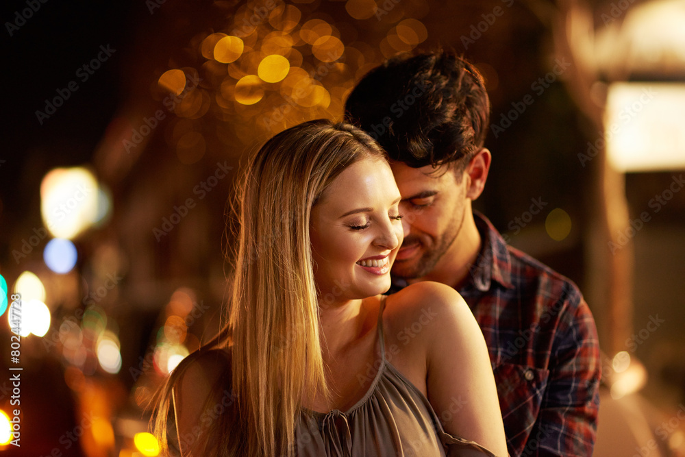 Couple, people and affection with smile in outdoor, together and support at night in London. Relationship, date and bonding for romance with sunset for care, relax and happiness as soulmate for love