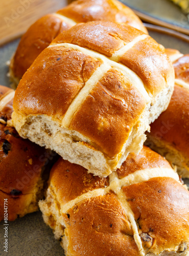 Traditional British Easter food, fresh baked cross buns with raisins or apples