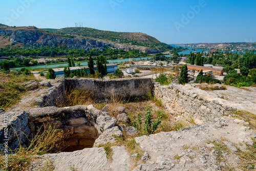 Photo of an old ruined fortress against the background of the city