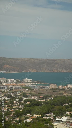  Slow motion, panormaic view to a bay with cliffs and buildings, in Javea, Alicante (Spain). photo