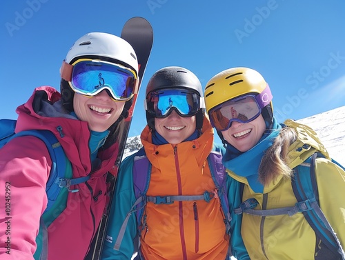 Three happy friends taking a selfie on a sunny ski slope, wearing colorful ski gear.
