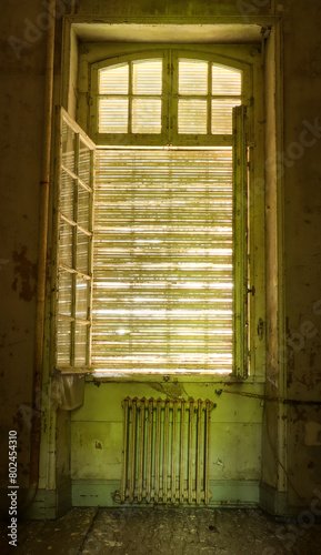 open window with an old rusty radiator
