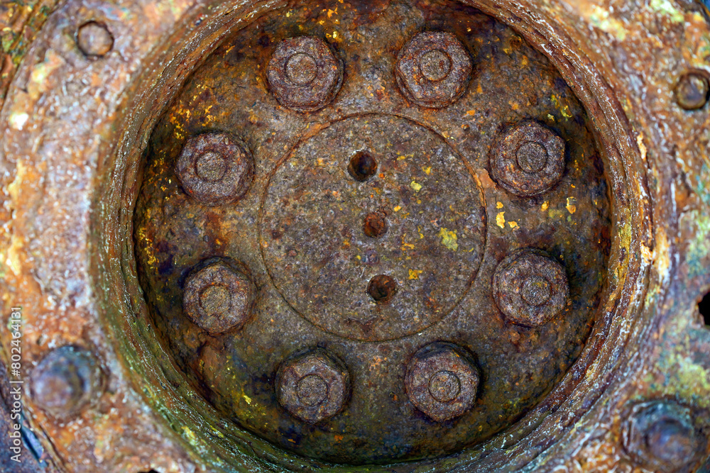 Rust hub of the old wheel, texture.Corrosive grunge rusted on old iron wheel. Pattern grunged rust as illustration for presentation background. Rusty corrosion or oxidized background.Close up.