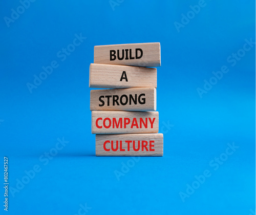 Company culture symbol. Wooden blocks with words Build a strong company culture. Beautiful blue background. Business and Company culture concept. Copy space.