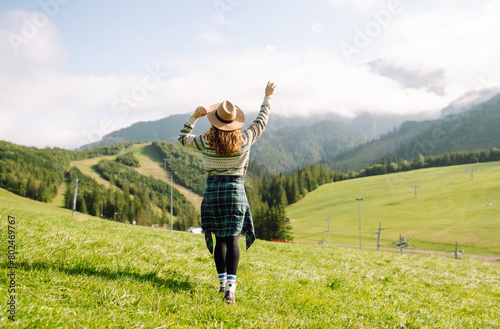Portrait of a young cute attractive smiling girl traveler travelling in a mountain valley. Adventure, travel concept.