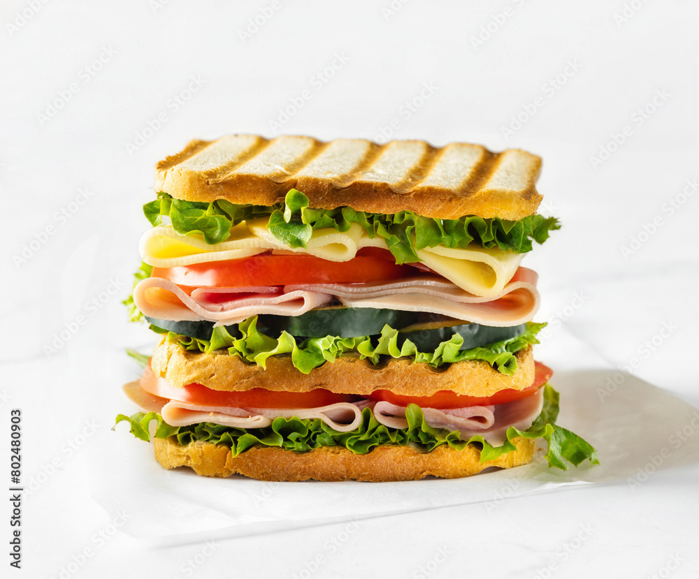 Big sandwich with vegetables and ham close up Big sandwich with vegetables and ham close up