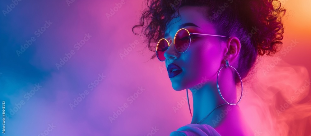 High Fashion female model in colorful bright neon lights posing in studio, night club. Beautiful model with glowing skin posing with neon colorful lights on the background.