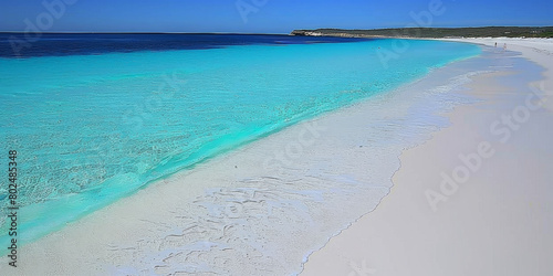 A beautiful beach with a blue ocean and white sand