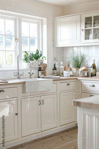 A modern kitchen design with white cabinetry and natural light Features clean lines and a welcoming atmosphere photo