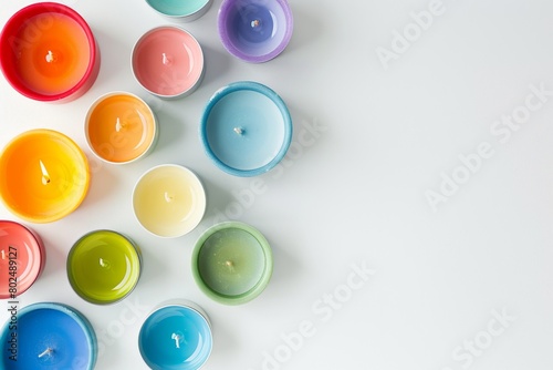 A vibrant array of tealight candles displayed neatly on a white surface, creating a calming and serene ambiance
