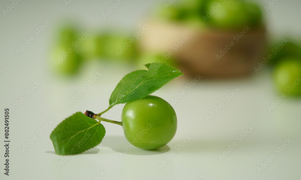green plum with branch on white background green plum with branch on white background