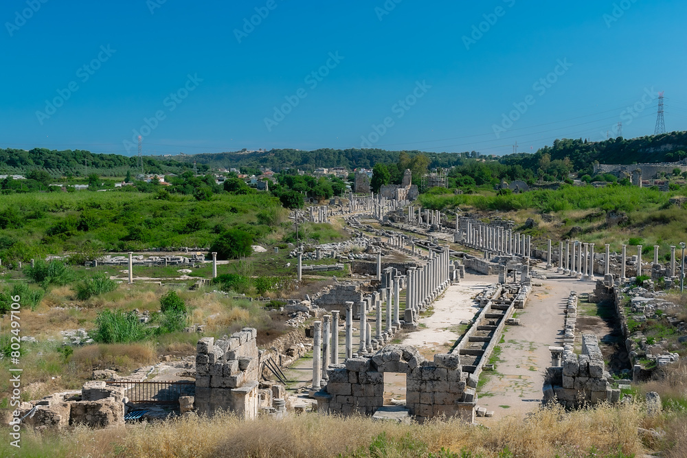Obraz premium View from a height of the ancient city of Perge. Ancient city surrounded by dense green vegetation.