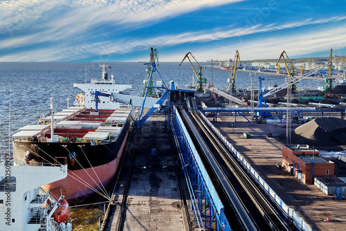Photography Coal harbor at maritime dry bulk terminal, bulk carrier under loading