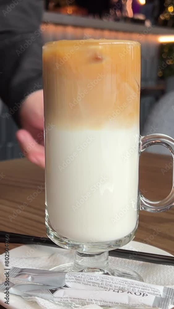 waiter serves two lattes, hot and cold, comparing the two flavors Ice latte and Hot late