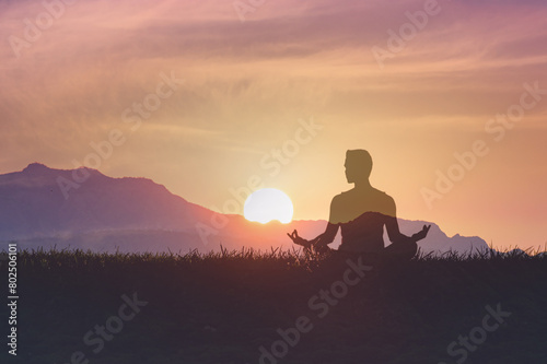 Man in yoga pose, zen meditation at sunset.  © kieferpix