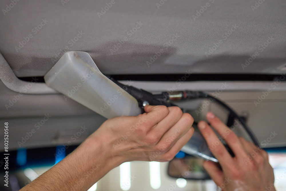 Obraz premium Carwash service, cleaning of car ceiling covering