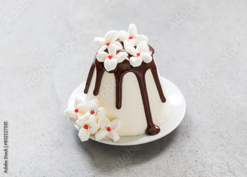 Holiday Easter. Cottage cheese festive dessert with chocolate. Decorated with white marshmallow flowers. Close-up