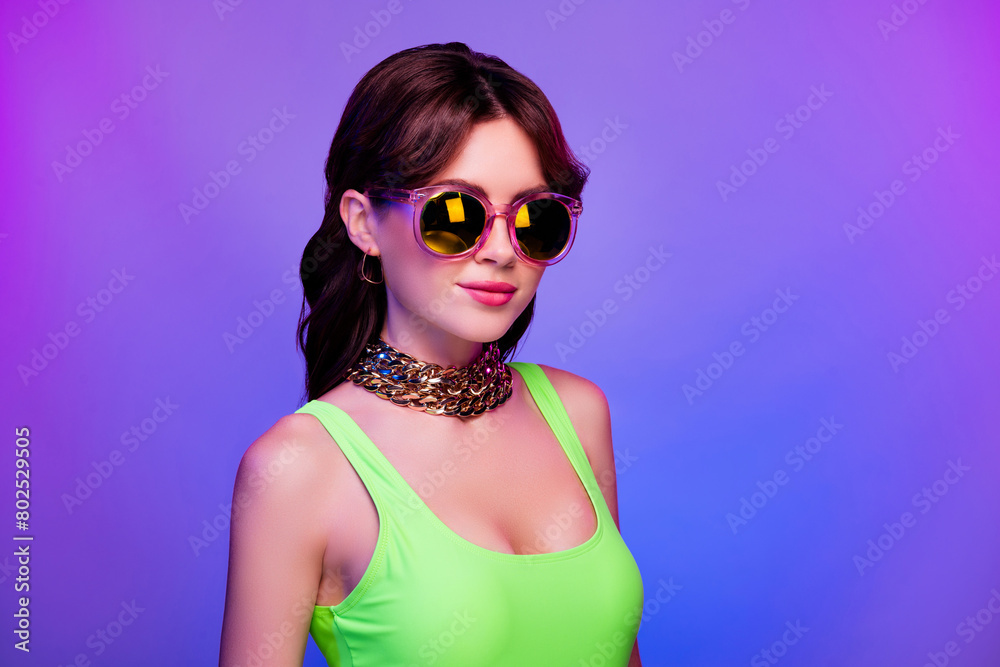 Photo of girl in sunglass green top look camera isolated bright ultraviolet color background Photo of girl in sunglass green top look camera isolated bright ultraviolet color background