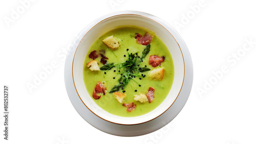 Green pea soup with bacon and croutons isolated on white background