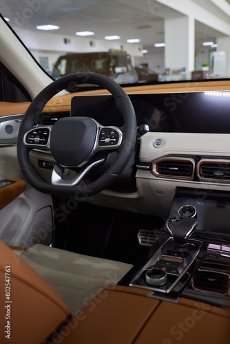 Macro shot of a steering wheel in a car with hood and automotive lighting © Евгений Вершинин