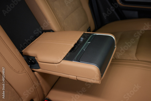 Luxury car back seat with open arm rest in sleek hardwood design © Евгений Вершинин