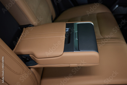 Luxury car back seat with open arm rest in sleek hardwood design © Евгений Вершинин