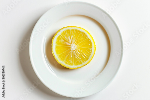A single slice of lemon on a plain white plate.