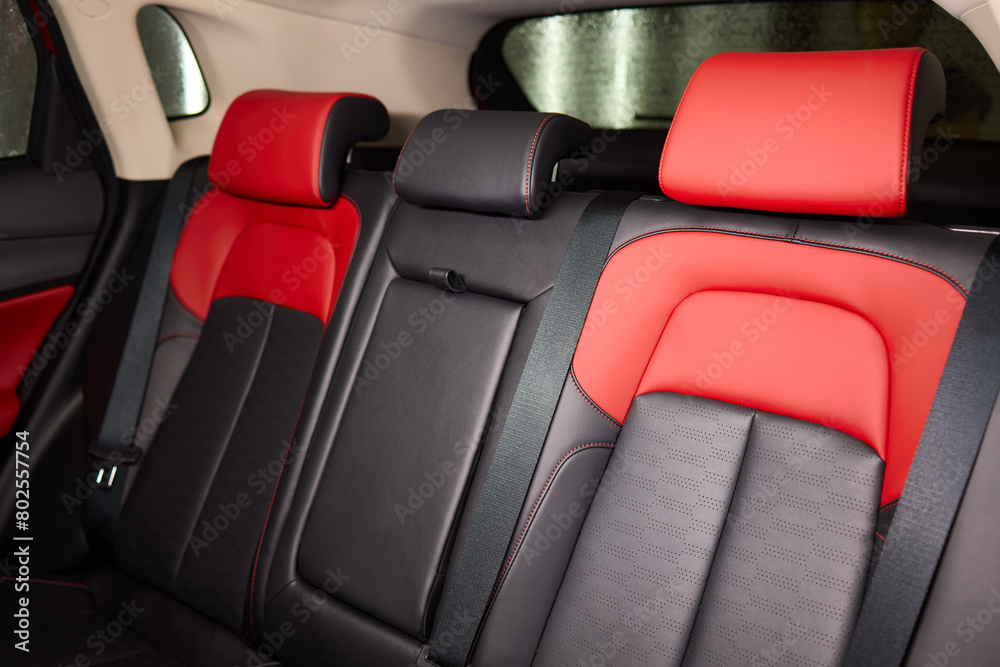 Obraz premium Red and black seats in the back of the car, part of the automotive design