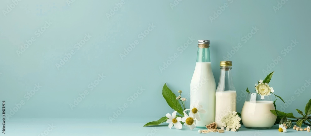 Ingredients for creating different plant-based dairy-free vegan milks and milk bottles on a blue background with space for text. Ingredients for creating different plant-based dairy-free vegan milks and milk bottles on a blue background with space for text.