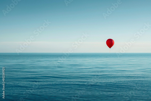 A single balloon drifting against a backdrop of a serene ocean, evoking a sense of tranquility.