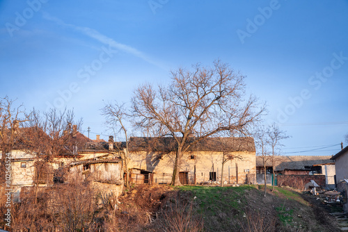 Facade of an old house building from an abandoned farmhouse in Kovin, banat, Voivodina, in Serbia. The region of Balkans, in Europe, is hit by a severe rural exodus emigration deserting the area. photo
