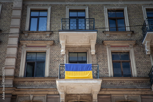 Flags of Ukraine waiving on a balcony in the center of Riga, Latvia, to show solidarity from the Latvians to ukrainians during the war in Ukraine against Russia.