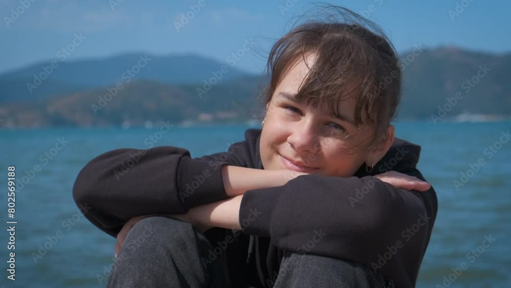 Teen traveler against breathtaking sea. A teen girl with happy smile enjoy the breathtaking seascape during her summer trip. Teen traveler against breathtaking sea. A teen girl with happy smile enjoy the breathtaking seascape during her summer trip.