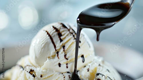 A scoop of creamy vanilla ice cream topped with a generous drizzle of organic balsamic oil for a unique and decadent dessert.