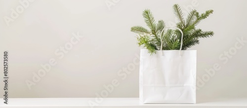 Plain white shopping bag filled with non-woven fabric placed on a white desk. Concept of a holiday sale. Mockup with empty space for your text. photo