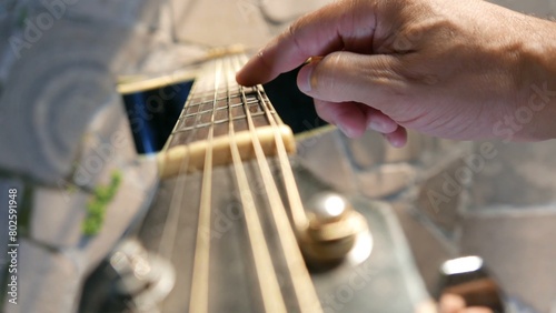 POV: a musician reaching for a guitar. A guitarist next to an acoustic guitar. Playing guitar day. A guitar fretboard.