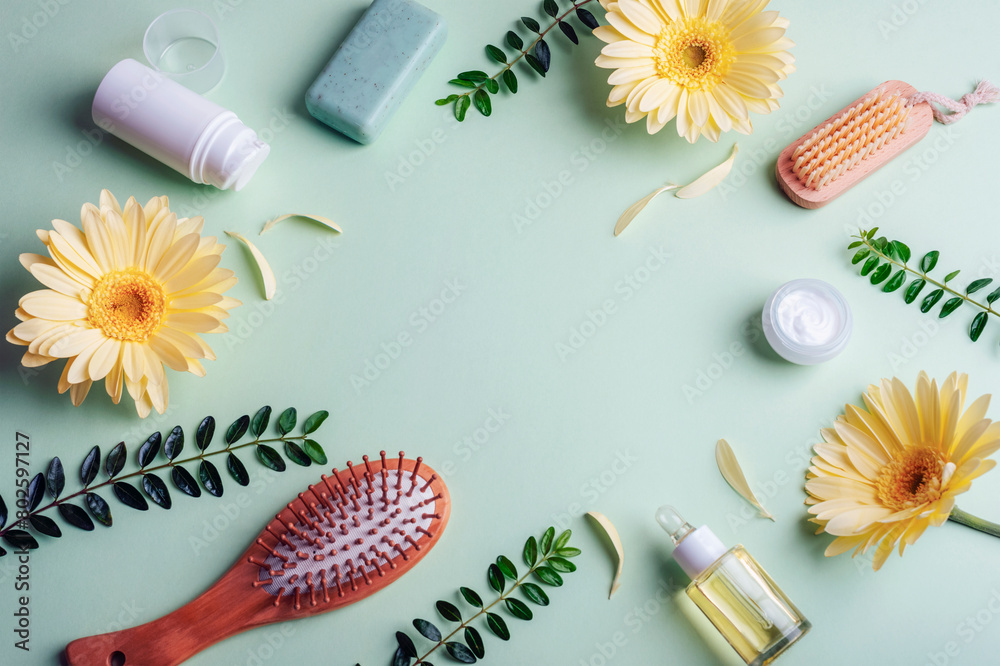 Beauty and spa accessories, cosmetics background with organic ingredients, skincare products and yellow gerbera flowers on green background. Top view, flat lay, copy space Beauty and spa accessories, cosmetics background with organic ingredients, skincare products and yellow gerbera flowers on green background. Top view, flat lay, copy space