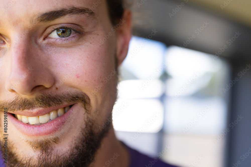 A young Caucasian male with smile, looking off camera at home A young Caucasian male with smile, looking off camera at home
