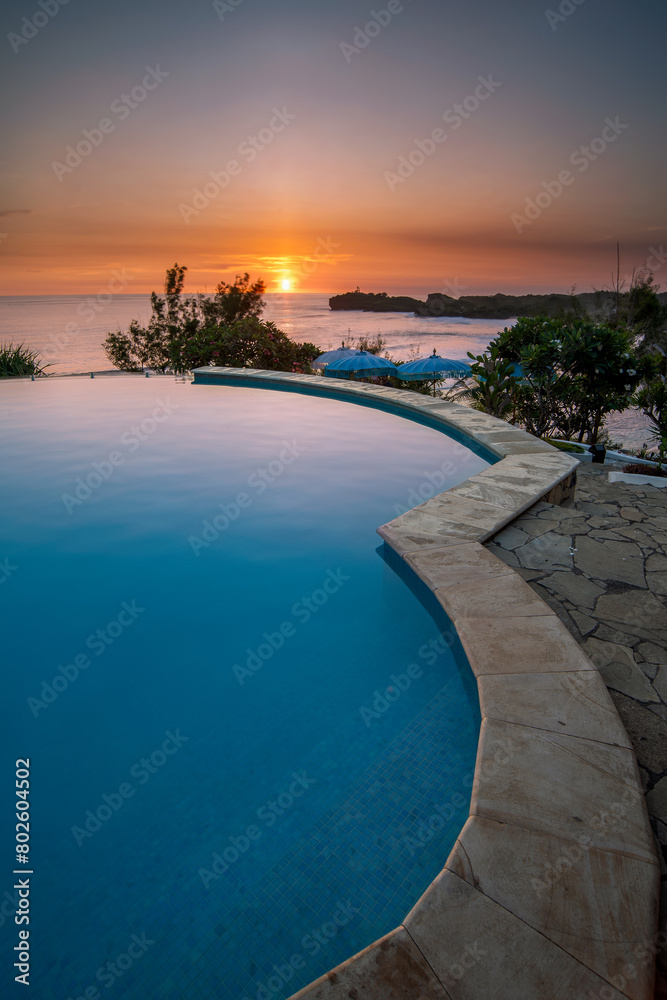 Sunset view from infinity pool beach lounge at Gunung Kidul Yogyakarta Indonesia