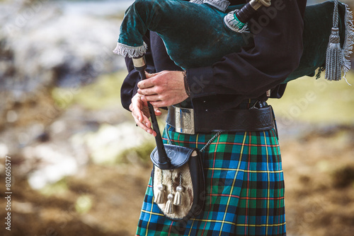 A man wearing a kilt and holding a pipe photo