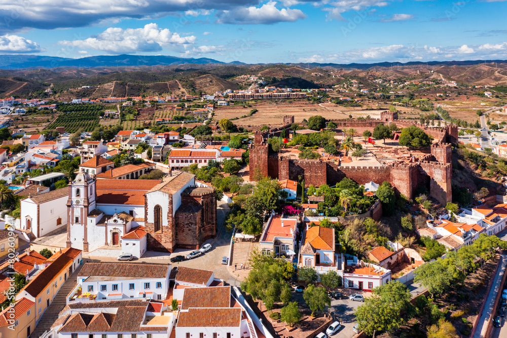 View of Silves town buildings with famous castle and cathedral, Algarve region, Portugal. Walls of medieval castle in Silves town, Algarve region, Portugal.