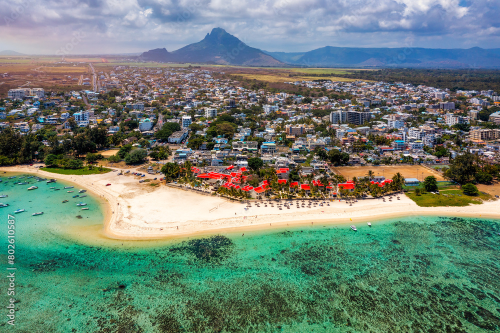 Beautiful Mauritius Island with gorgeous beach Flic en Flac, aerial view from drone. Mauritius, Black River, Flic-en-Flac view of oceanside village beach and luxurious hotel in summer.